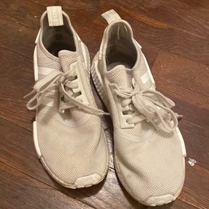 All white adidas NMD sneakers